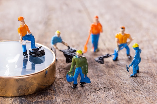 Figures construction worker is working on a cracked area