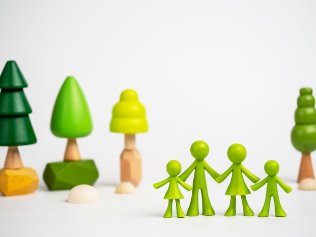 Figures of men with colorful wooden trees in the background