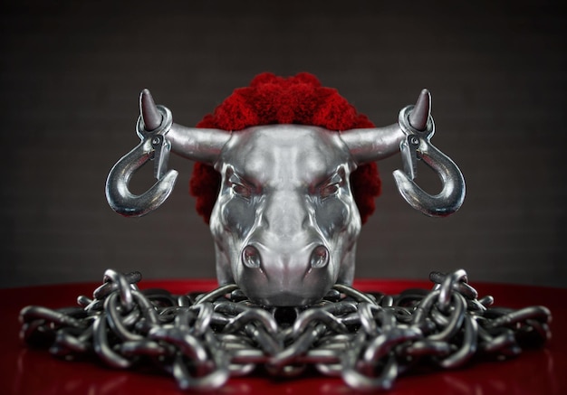 Figurine of a bull's head with transportation hooks on horns and a metal chain