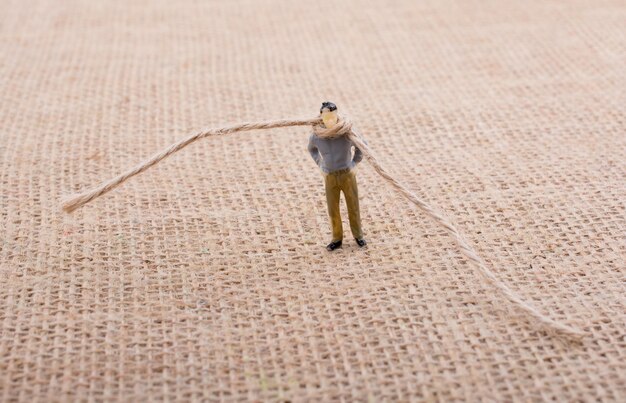 Figurine man with a rope on his neck