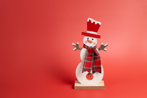 Figurine merry snowman on red christmas background High quality photo