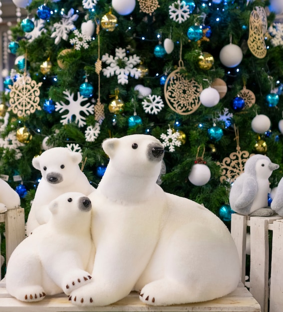 Premium Photo | Figurine polar bears toy, near the christmas tree ...