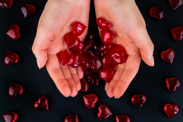 Figurines heart in hands as a symbol of love