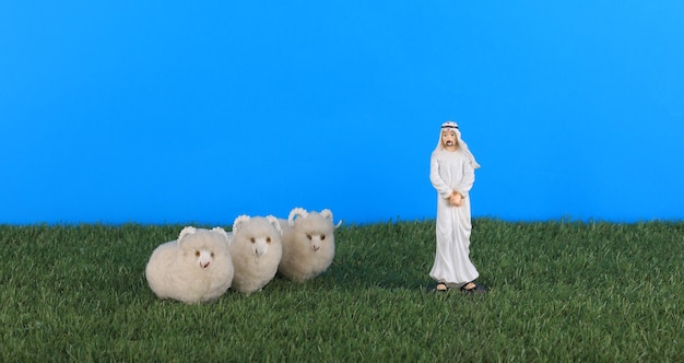 Figurines of a sheep and a lamb on a grass field