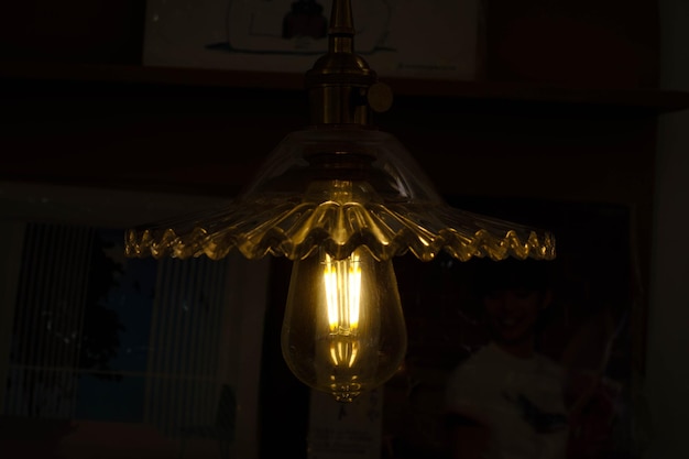 필라멘트 LED 전구가 어두운 방에서 빛납니다.