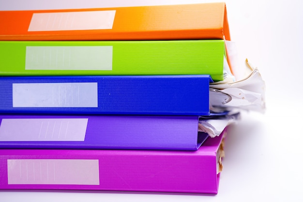 File Folder Binder stack of multi color on table in office.