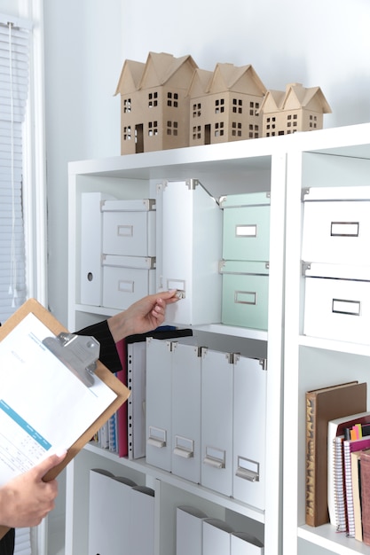 File folders, standing on shelves in the background