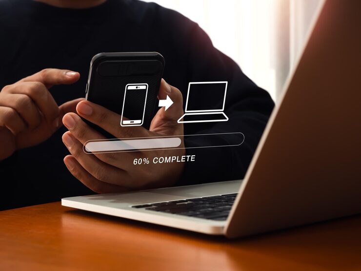 Photo file transfer data migration transmission backup files concept loading progress bar and smartphone sending to computer icons appear while person using mobile phone to sharing file with 2 devices
