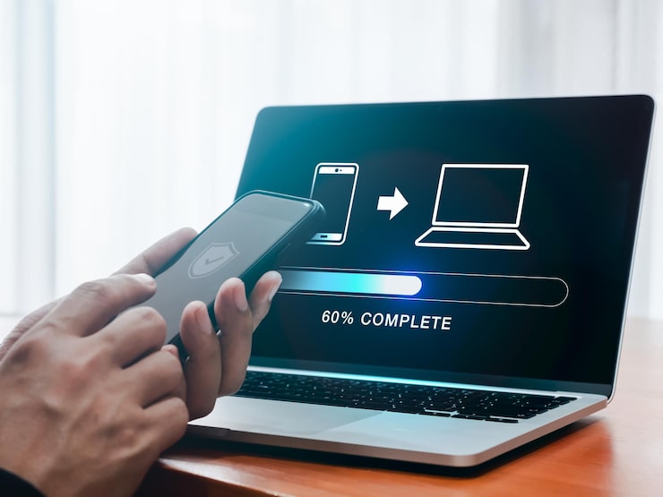 Photo file transfer data migration transmission backup files concept loading progress bar and smartphone sending to computer icons appear while person using mobile phone to sharing file with 2 devices