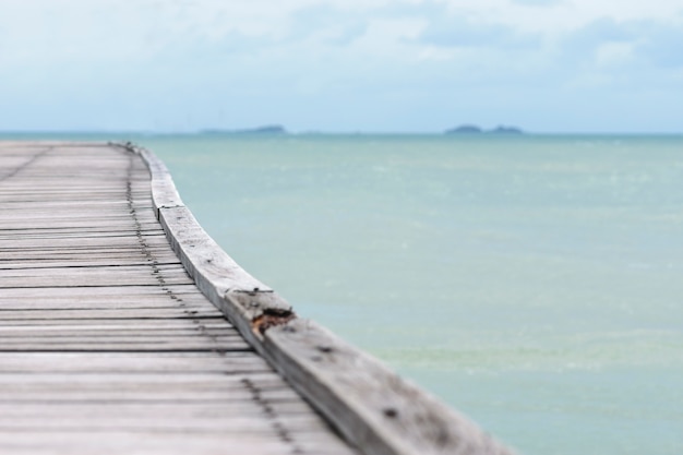 Filed wooden bridge into the sea.