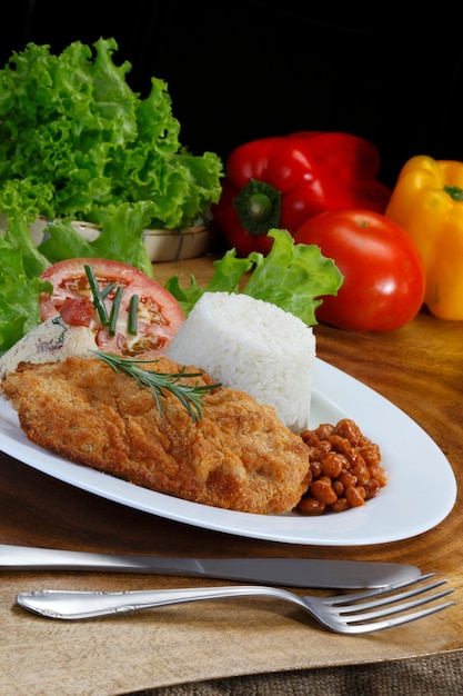 Filet breaded with salad and rice