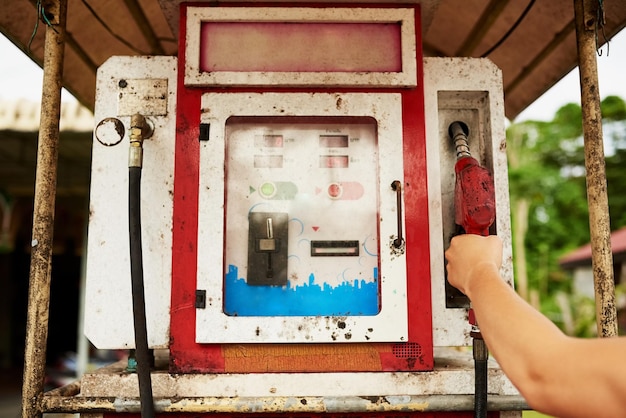 Fill er up Cropped shot of a man using an old pump at a gas station