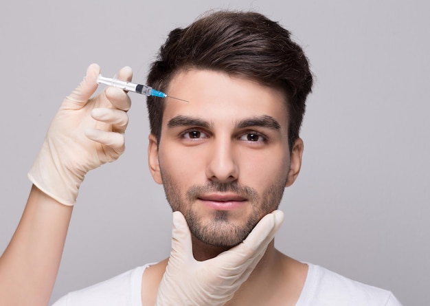 Filler injection for male face in beauty clinic