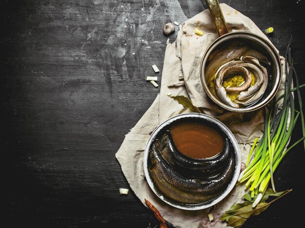 Fillet of pickled herring with spices in a saucepan