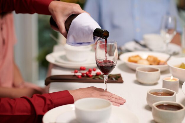 Filling glass with red wine