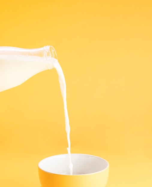 Photo filling milk into a cup