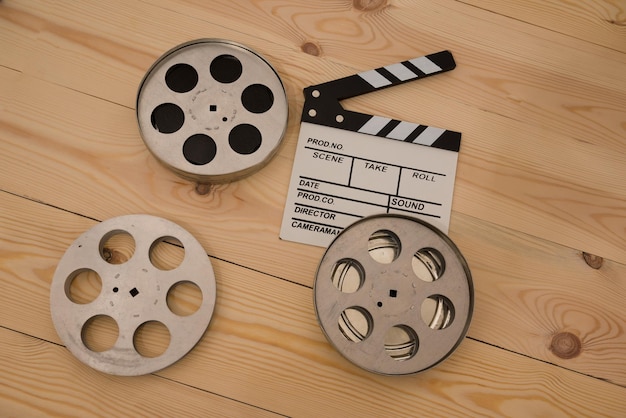 Film camera chalkboard and roll on wooden table