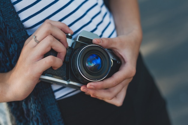 Film camera in the hands of the girl