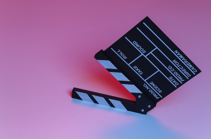 Photo film clapper board in blue red neon light. cinema industry, entertainment