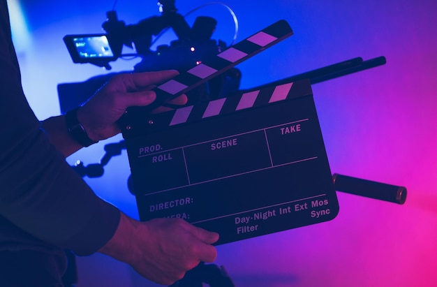 Photo film making professional with clapperboard in his hands