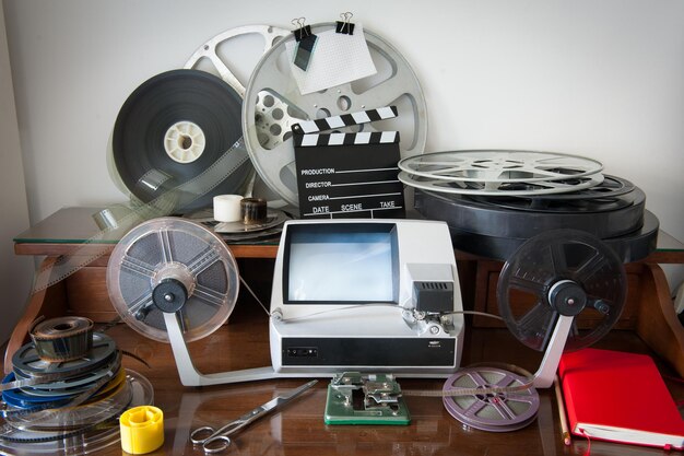 Photo film slate and reel spools with equipment on table