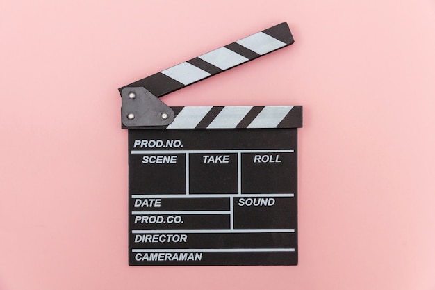 Filmmaker profession. Classic director empty film making clapperboard or movie slate isolated on pink wall. Video production film cinema industry concept. Flat lay top view copy space .