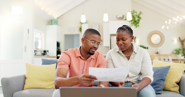 Photo finance budget and couple with laptop on sofa with bills paperwork and life insurance documents financial planning mortgage and black man and woman on computer for pension payment or investment