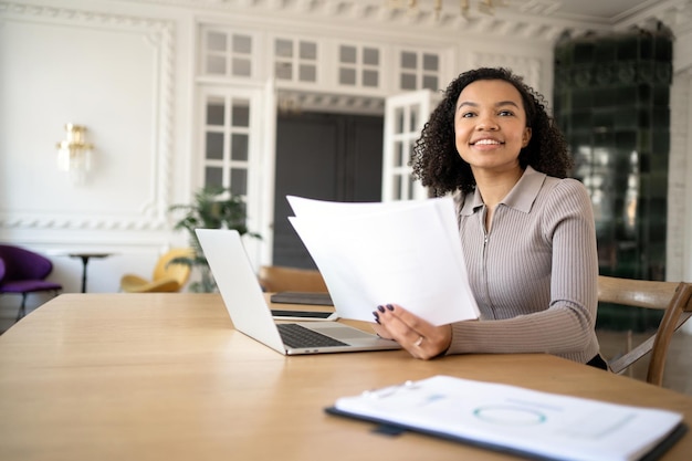 finance and budget uses a laptop a woman with glasses a manager works in the office a report