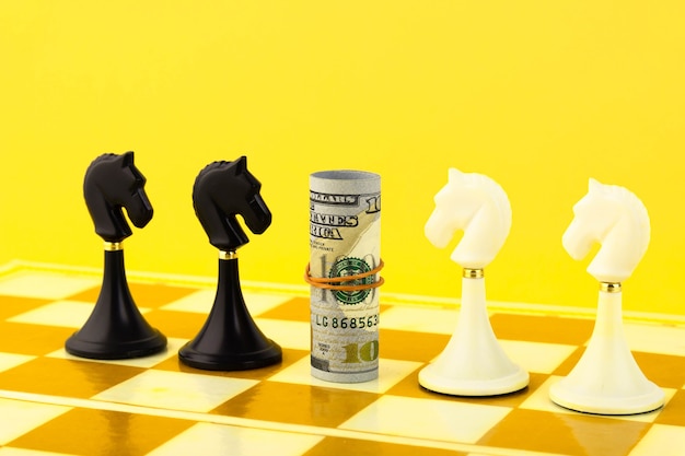 Photo finance concept with dollar bills and chess horse