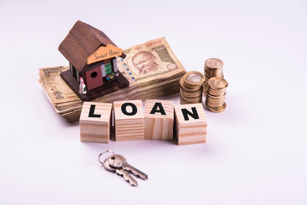 Finance and Housing Loan or purchase in India -  Concept showing 3D house model, indian currency notes and calculator etc