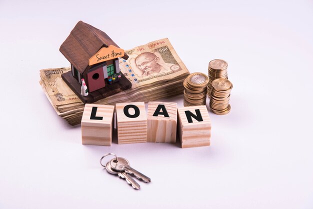 Finance and Housing Loan or purchase in India -  Concept showing 3D house model, indian currency notes and calculator etc
