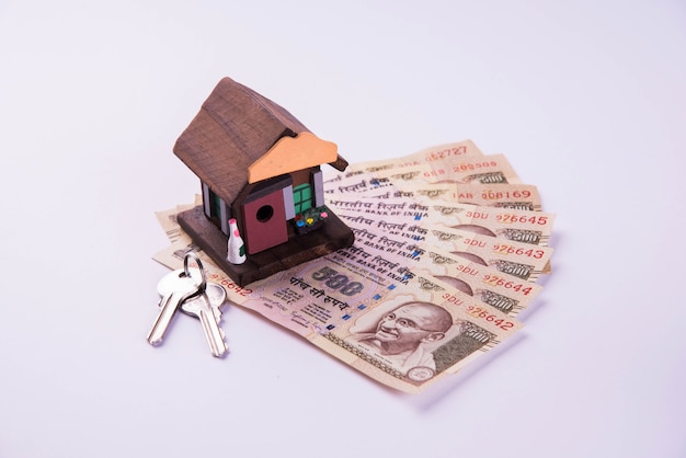 Finance and Housing Loan or purchase in India -  Concept showing 3D house model, indian currency notes and calculator etc