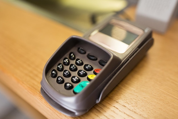 finance, money, technology, payment and people concept - close up of bank card reader or atm terminal