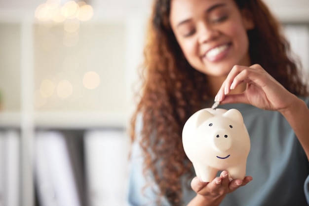 Photo finance savings and closeup of a piggy bank with money for future investment budget or wealth cash accounting and woman investing coins in a funds jar for profit growth or financial freedom