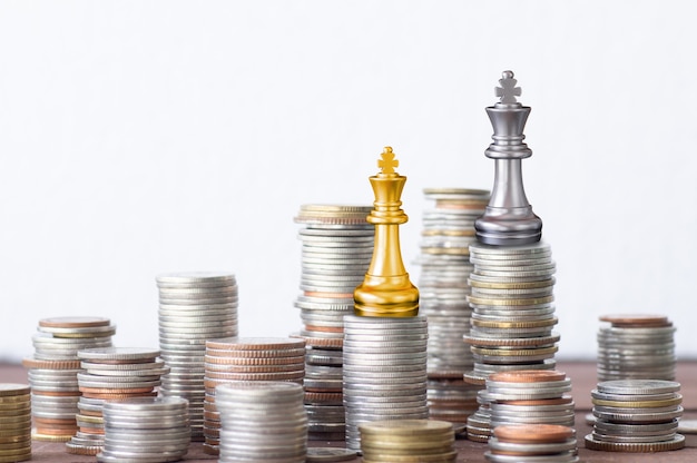 Finance and successful investment concept, stacked of coin king gold and silver chess