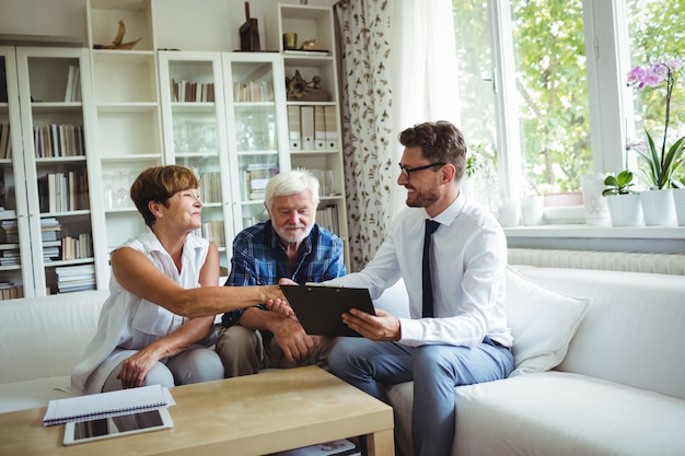 Financial advisor shaking hands with senior woman