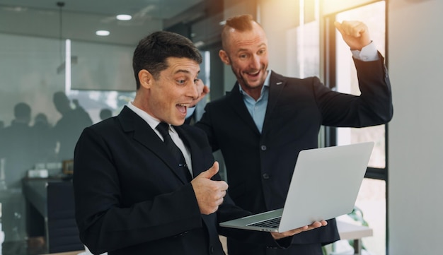 Financial analysts analyze business financial reports on a digital tablet planning investment project during a discussion at a meeting of corporate showing the results of their successful teamwork