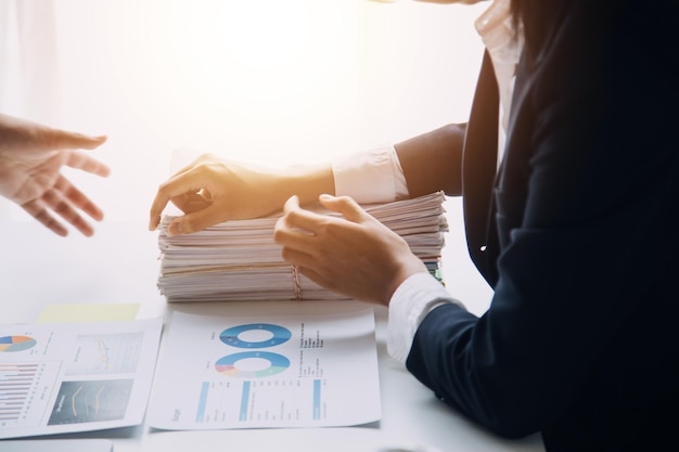 Financial analysts analyze business financial reports on a digital tablet planning investment project during a discussion at a meeting of corporate showing the results of their successful teamwork