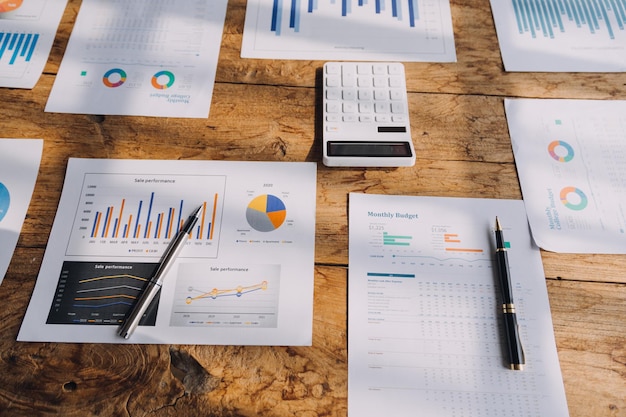 Financial analysts analyze business financial reports on a digital tablet planning investment project during a discussion at a meeting of corporate showing the results of their successful teamwork