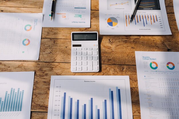 Financial analysts analyze business financial reports on a digital tablet planning investment project during a discussion at a meeting of corporate showing the results of their successful teamwork