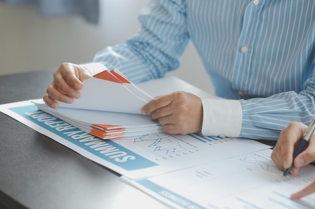 Financial analysts analyze business financial reports on a digital tablet planning investment project during a discussion at a meeting of corporate showing the results of their successful teamwork