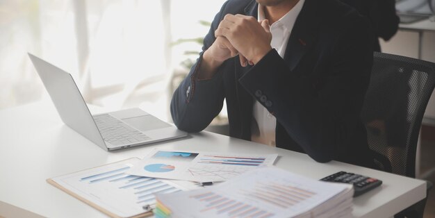 Financial analysts analyze business financial reports on a digital tablet planning investment project during a discussion at a meeting of corporate showing the results of their successful teamwork