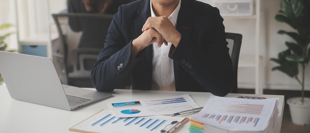 Financial analysts analyze business financial reports on a digital tablet planning investment project during a discussion at a meeting of corporate showing the results of their successful teamwork