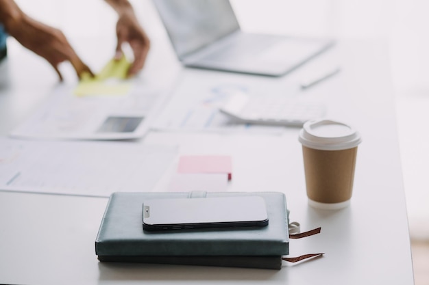 Financial analysts analyze business financial reports on a digital tablet planning investment project during a discussion at a meeting of corporate showing the results of their successful teamwork