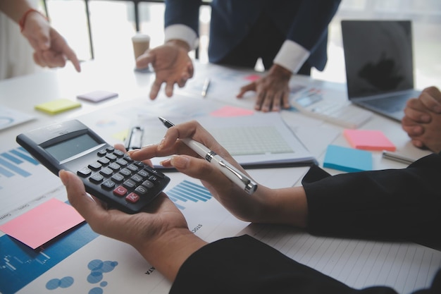 Financial analysts analyze business financial reports on a digital tablet planning investment project during a discussion at a meeting of corporate showing the results of their successful teamwork