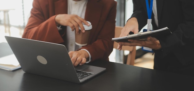 Financial analysts analyze business financial reports on a digital tablet planning investment project during a discussion at a meeting of corporate showing the results of their successful teamwork