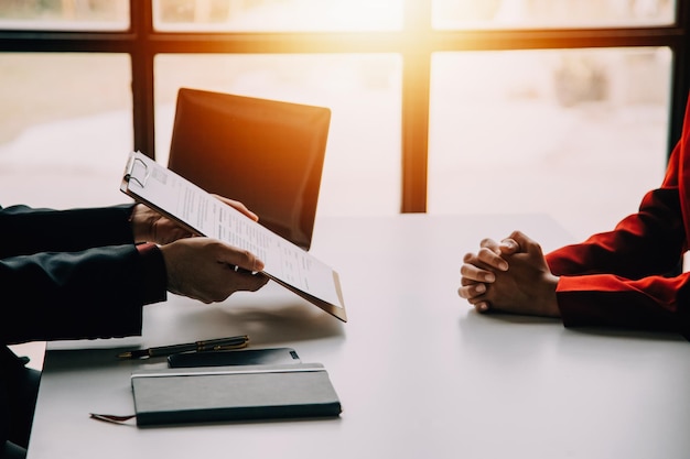 Financial analysts analyze business financial reports on a digital tablet planning investment project during a discussion at a meeting of corporate showing the results of their successful teamwork