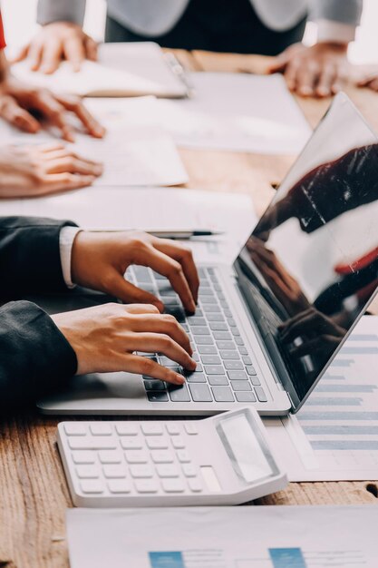 Financial analysts analyze business financial reports on a digital tablet planning investment project during a discussion at a meeting of corporate showing the results of their successful teamwork