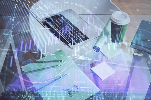 Financial chart drawing and table with computer on background Multi exposure Concept of international markets