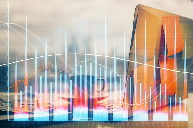 Financial chart drawing and table with computer on background Multi exposure Concept of international markets